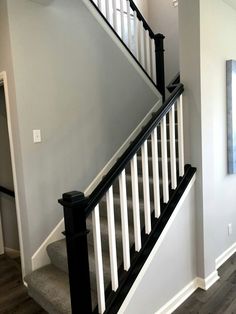 the stairs in this house are painted white and black