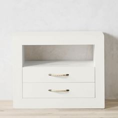 a white nightstand with two drawers on it