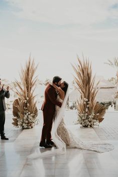 a bride and groom kissing at their wedding ceremony