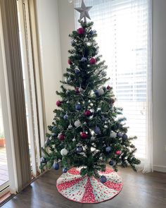 a decorated christmas tree in the corner of a room