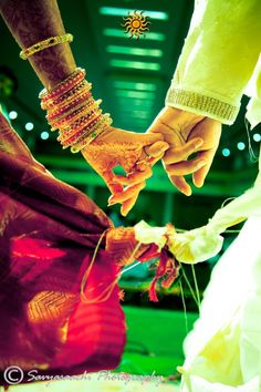 the bride and groom are holding hands with each other on their wedding day in india