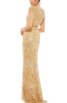 Light up the evening in this shapely column gown covered in dazzling sparkle and trimmed with icy eye-catching fringe. Jewel neck Short sleeves Partially lined 100% polyester Spot clean Imported Asian Owned/Founded Beaded Fringe Dress, Nude Gown, Mac Duggal Dress, Embellished Shorts, Trumpet Gown, Dress Guide, Prom Designs, Designer Prom Dresses, Column Gown