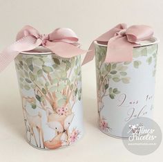 two tins with pink bows on them sitting next to each other in front of a white background