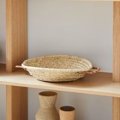 a wicker basket sitting on top of a wooden shelf