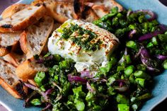 a blue plate topped with bread and veggies