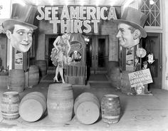 an old black and white photo of some barrels in front of a sign that says see america thirst