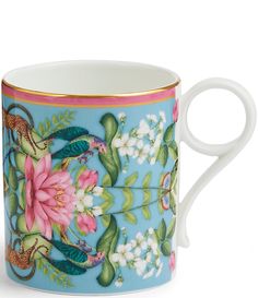 a coffee cup with flowers and birds painted on it