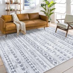 a living room with a couch, chair and rug