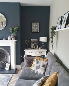 a living room filled with furniture and a fire place in front of a wall mounted mirror