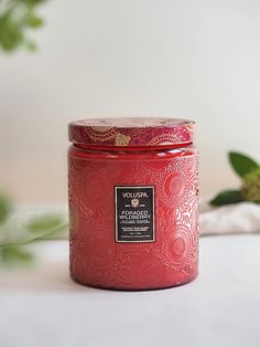 a red candle sitting on top of a table