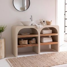 a bathroom with a sink, mirror and shelving unit in the middle of it