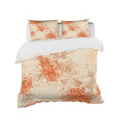 an orange and white flowered comforter on a bed with two pillowcases