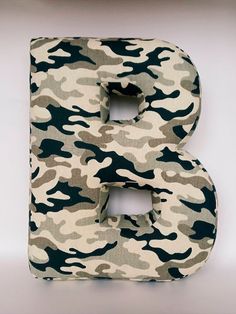 the letter b is made up of camouflage fabric