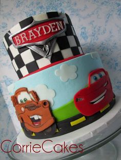 a three tiered cake with cars on it