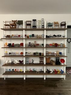 a room filled with lots of shelves covered in different types of chairs and other items