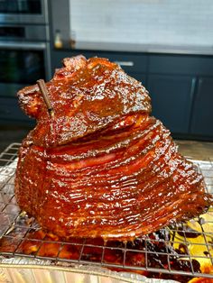 a large pile of ribs sitting on top of a metal rack next to other foods