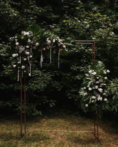 an outdoor wedding ceremony with white flowers and greenery