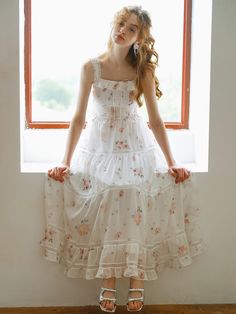 This product, the Cest Sweet Floral Slimming Dress, beautifully combines romantic floral patterns with a flattering silhouette. The dress features a fitted bodice with delicate straps and a flowing tiered skirt, creating an ethereal and feminine look. The intricate lace detailing adds a touch of elegance, making it perfect for both casual outings and special occasions. - This dress showcases a fitted bodice with delicate straps, enhancing its romantic appeal.- The tiered skirt flows gracefully, providing a flattering and slimming silhouette.- Intricate lace detailing adds sophistication and elegance to the overall design.- The floral pattern is charming and timeless, suitable for various events.- A handmade Cali medal decoration has been attached to the lower right side of the front p Cottagecore Tiered Dress For Garden Party, Delicate Spring Dress With Delicate Straps, Tiered Cottagecore Dress For Garden Party, Tiered Dress With Adjustable Straps For Garden Party, Tiered Garden Party Dress With Adjustable Straps, Delicate Ruffled Dress For Garden Party, Cottagecore Tiered Skirt Dress For Garden Party, Delicate Ruffled Garden Party Dress, Delicate Strap Summer Dresses