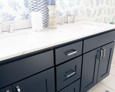 a bathroom vanity with blue and white wallpaper