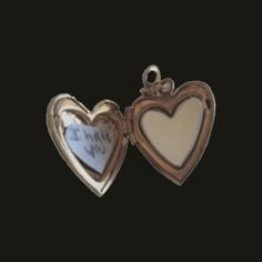 two heart shaped lockes with the words i love you written on them in gold and white