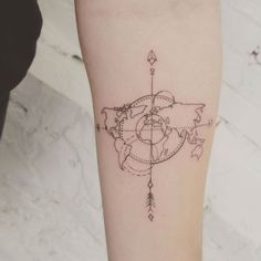 a woman's leg with a tattoo on it that has a world map and arrows