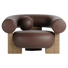 a brown leather chair with wooden legs and two balls on the armrests, sitting in front of a white background