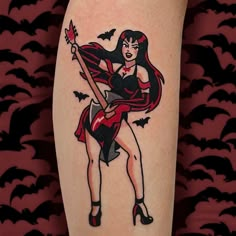 a woman with a bat tattoo on her arm holding a guitar and bats in the background