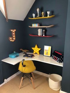 a room with a desk and shelves on the wall