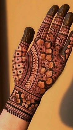 a hand with henna tattoos on it