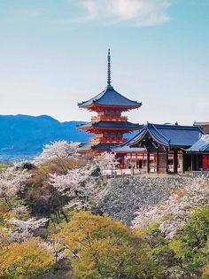 the pagoda is surrounded by trees and flowers