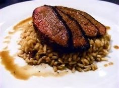 a white plate topped with meat and rice