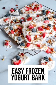 easy frozen yogurt bark with berries and blueberries on top, sitting on a cooling rack