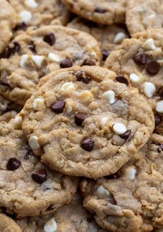 chocolate chip cookies with white and brown chips are piled on top of eachother