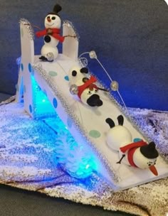 a cake shaped like a slide with pandas on it and snowing down the side