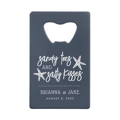 a bottle opener with the words sandy toes and salty kisses written on it in white ink