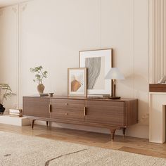 a living room scene with focus on the sideboard and artwork hanging on the wall