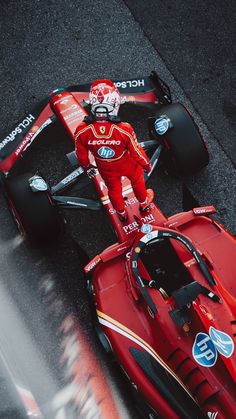 a man standing on top of a race car