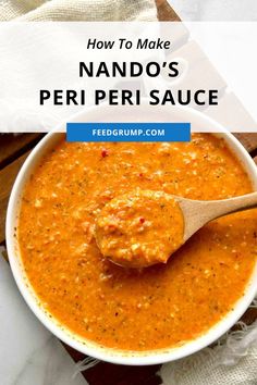 a bowl of red pepper sauce with a wooden spoon in it and the words how to make nando's peri peri sauce