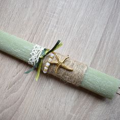 a napkin wrapped in burlock and tied with ribbon on top of a wooden table