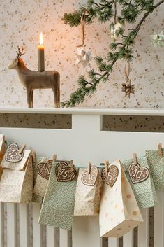 small christmas stockings hung on the radiator in front of a deer and tree