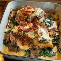 a casserole dish with chicken, spinach and mushrooms