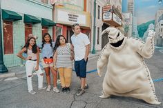 a group of people standing around a giant stuffed animal