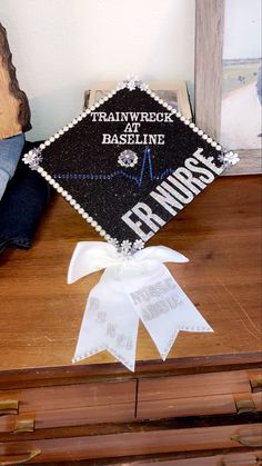 a decorated graduation cap sitting on top of a wooden table