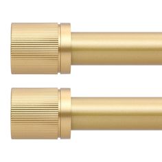 two gold colored metal objects on a white background