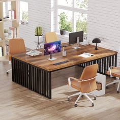 an office desk with two chairs and a computer monitor