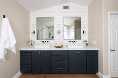 a large bathroom with two sinks and mirrors