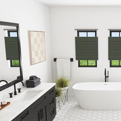 a large white bath tub sitting in a bathroom next to two windows with blind shades on them