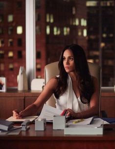 a woman sitting at a desk in an office