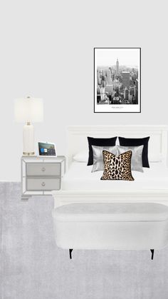 a white bed sitting next to a night stand