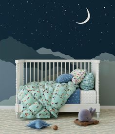 a child's room with a bed, night sky and stars